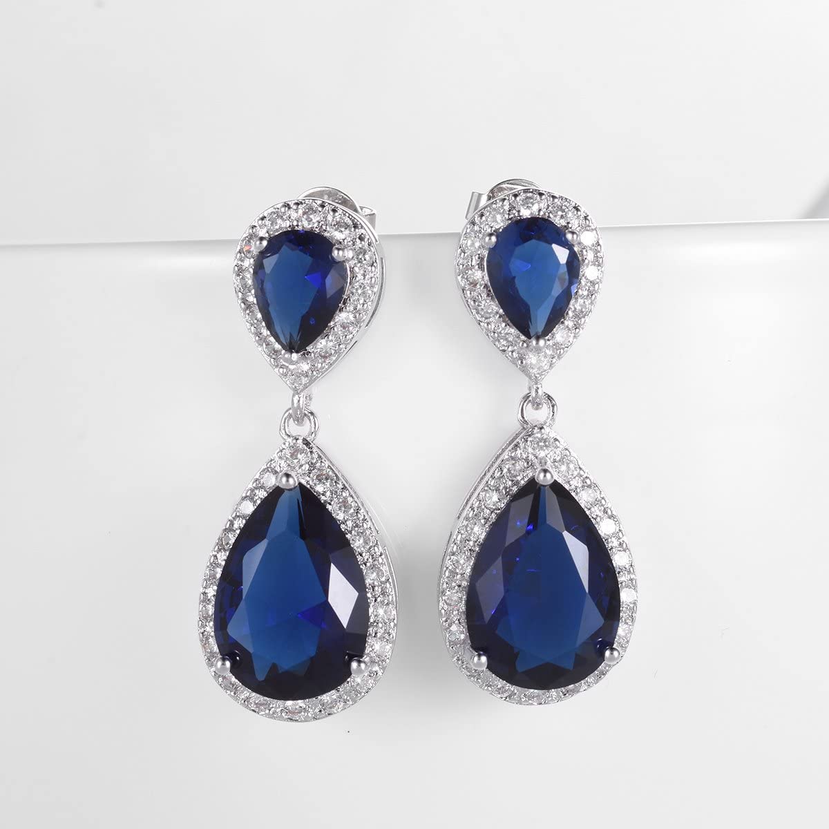 Elegance – White Gold Finish Cluster Royal Blue Created Diamond Teardrop Dangle Earrings