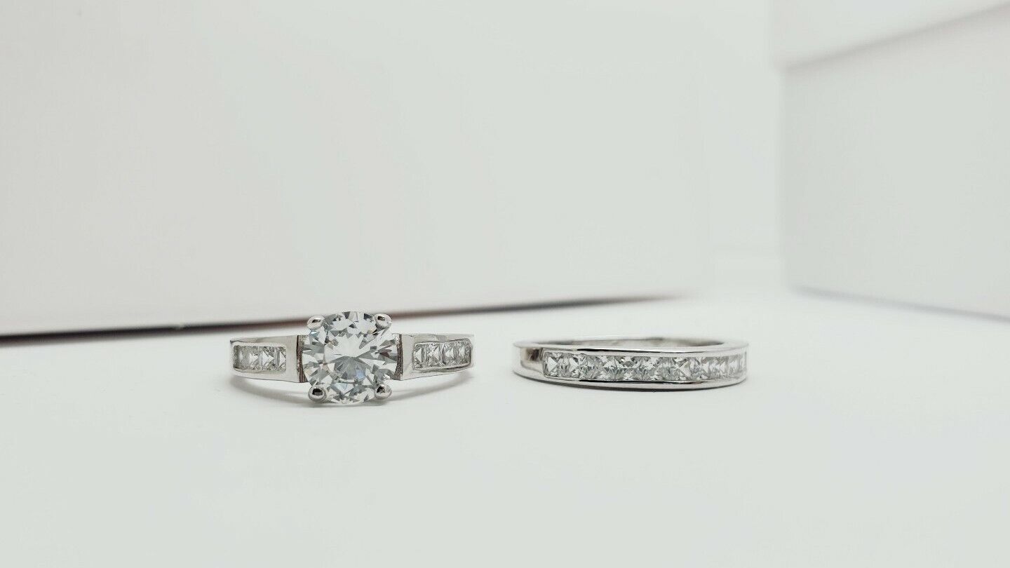 White gold finish created diamond solitaire shoulder set ring set